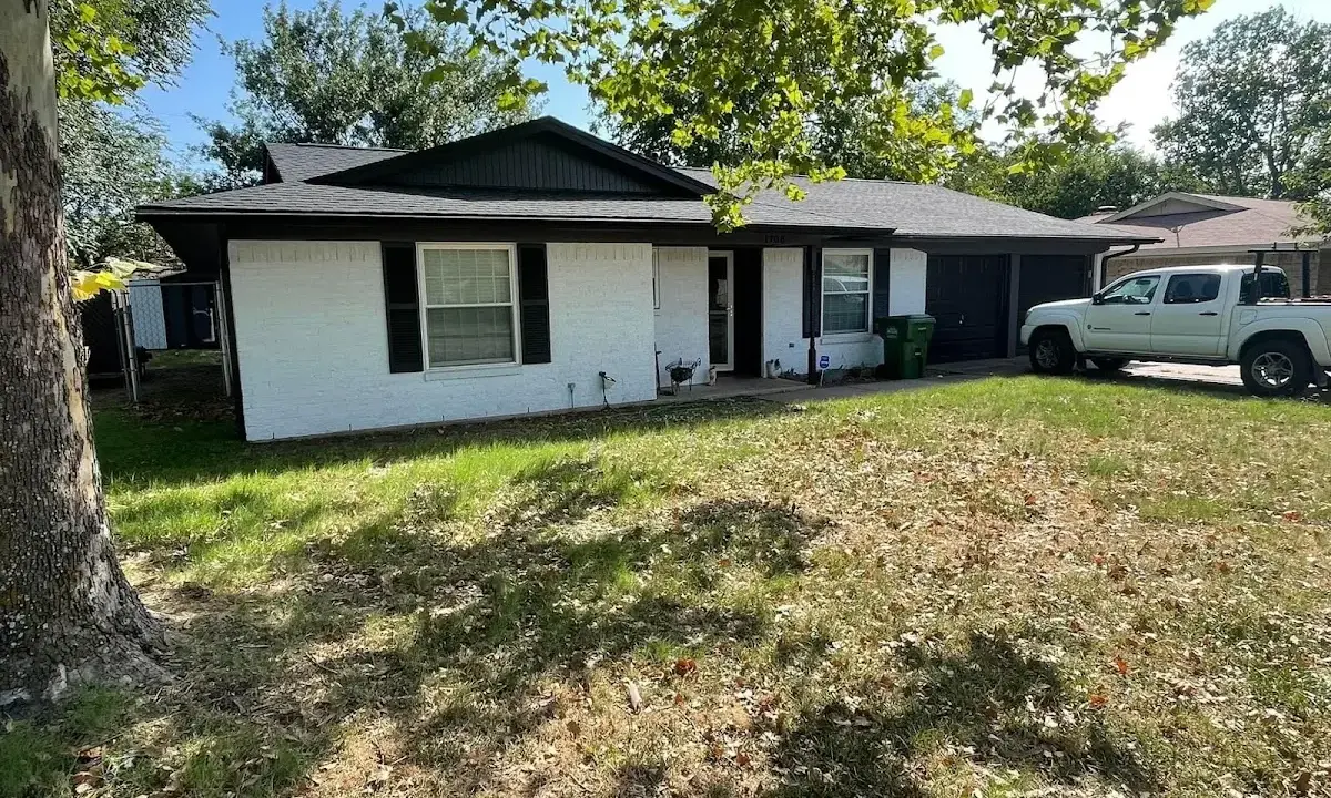 Professional roofing crew working on a residential roof in Four Corners